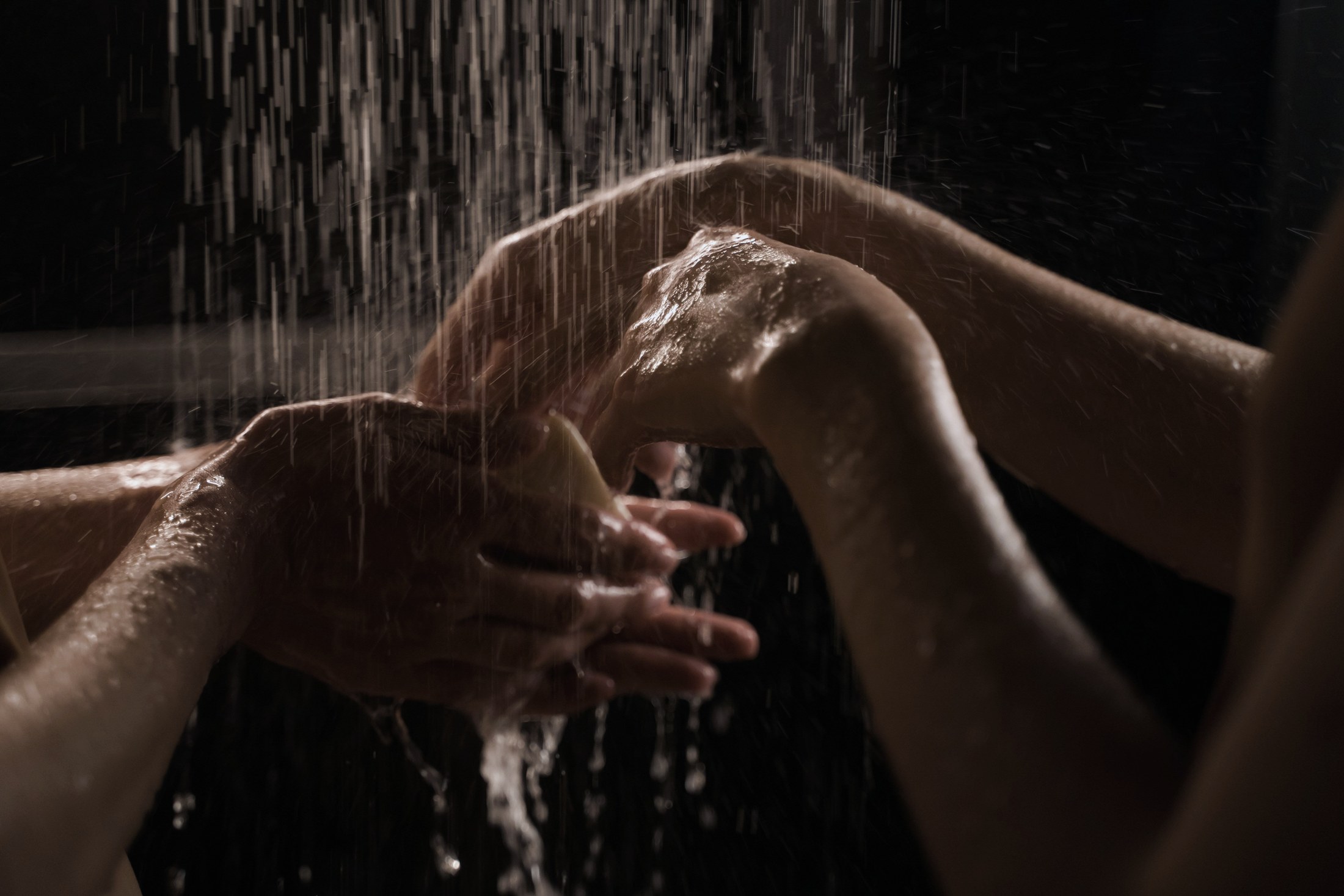 Person washing under a shower