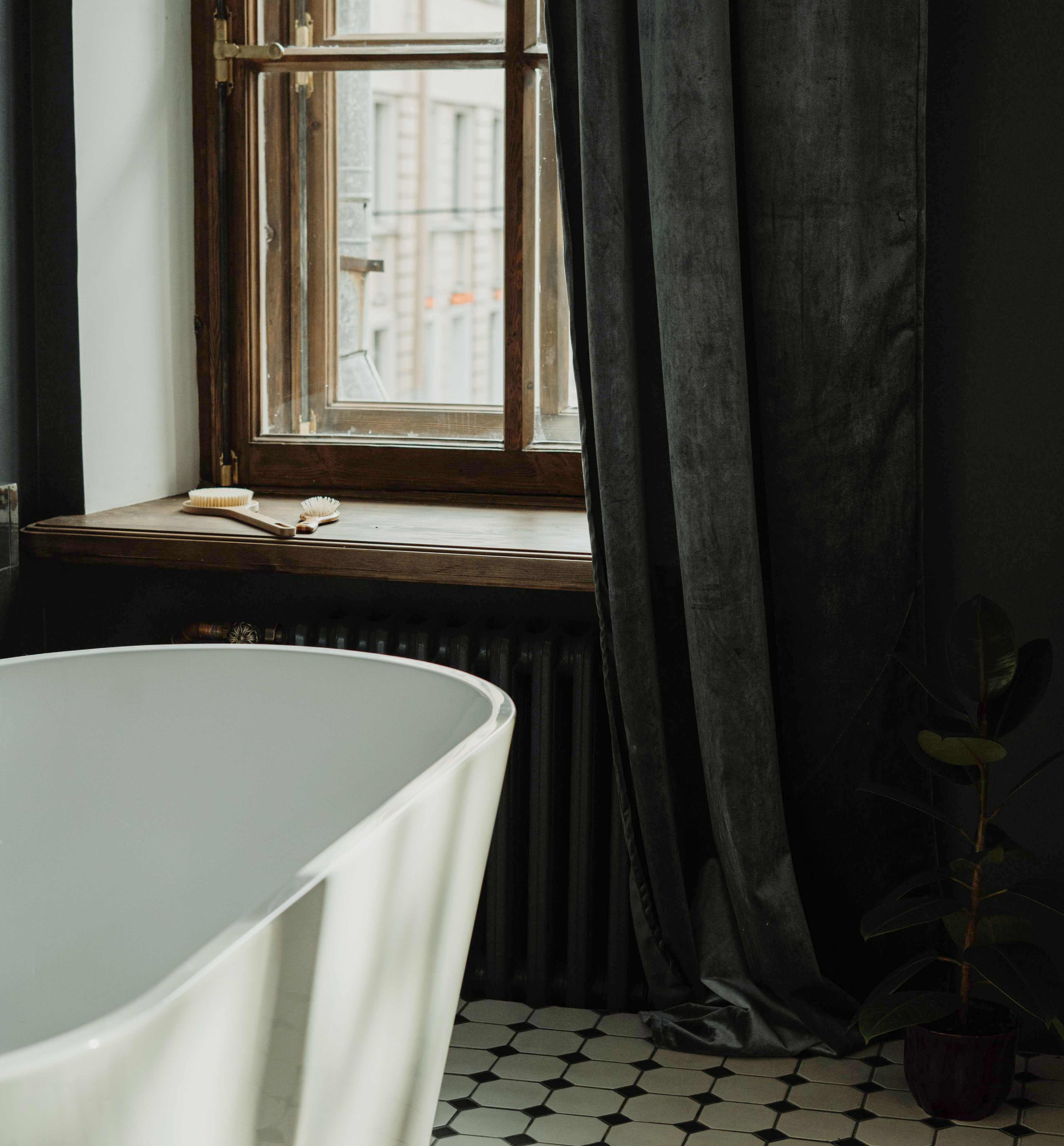Bathroom with a bathtub beneath a window