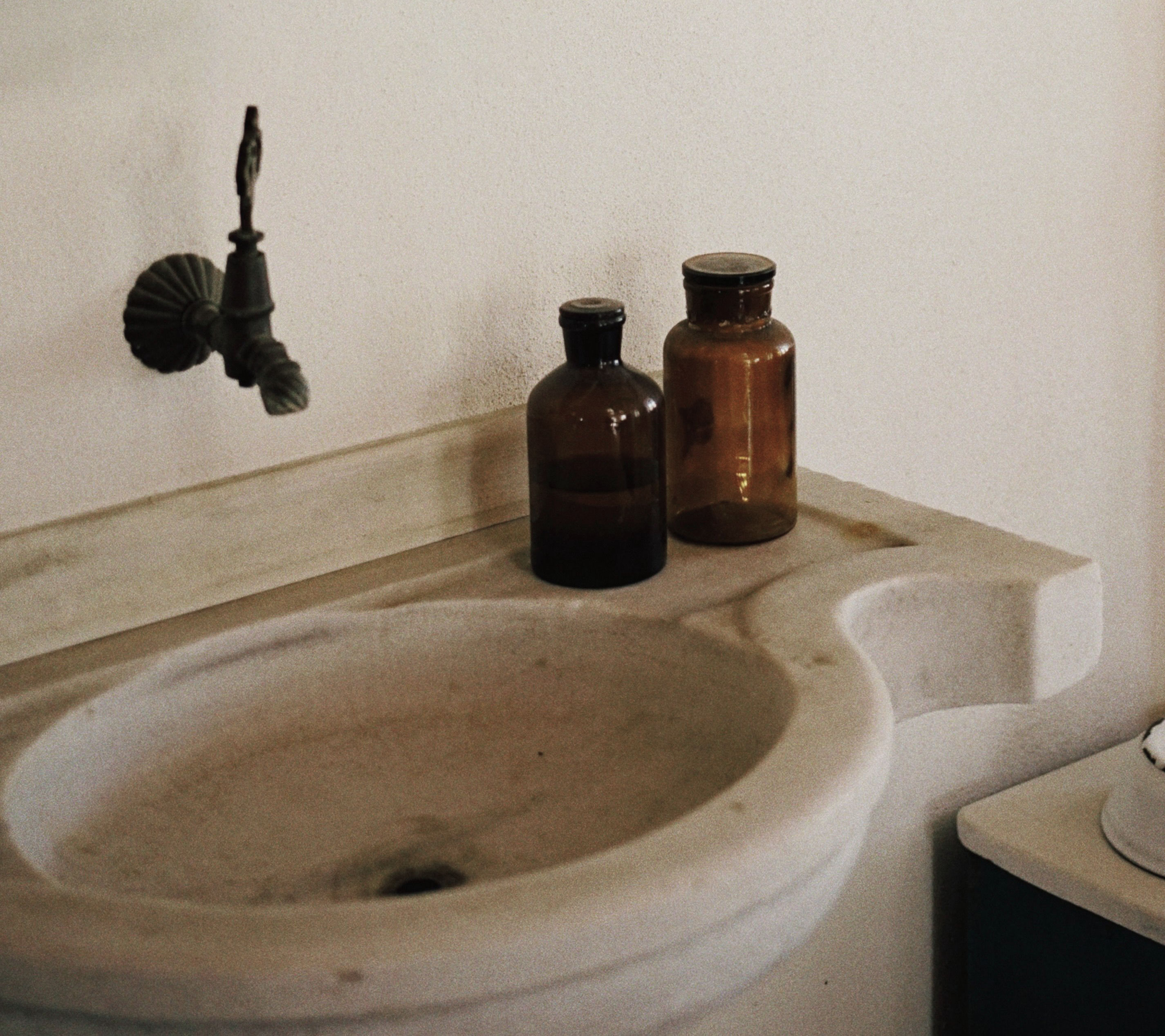 A bathroom sink with two bottles